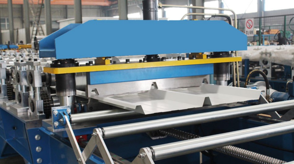Roll forming machine producing steel roof panels.